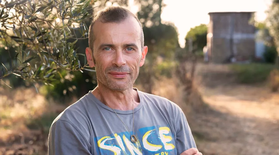 Portrait photo of Andrea stood outside.